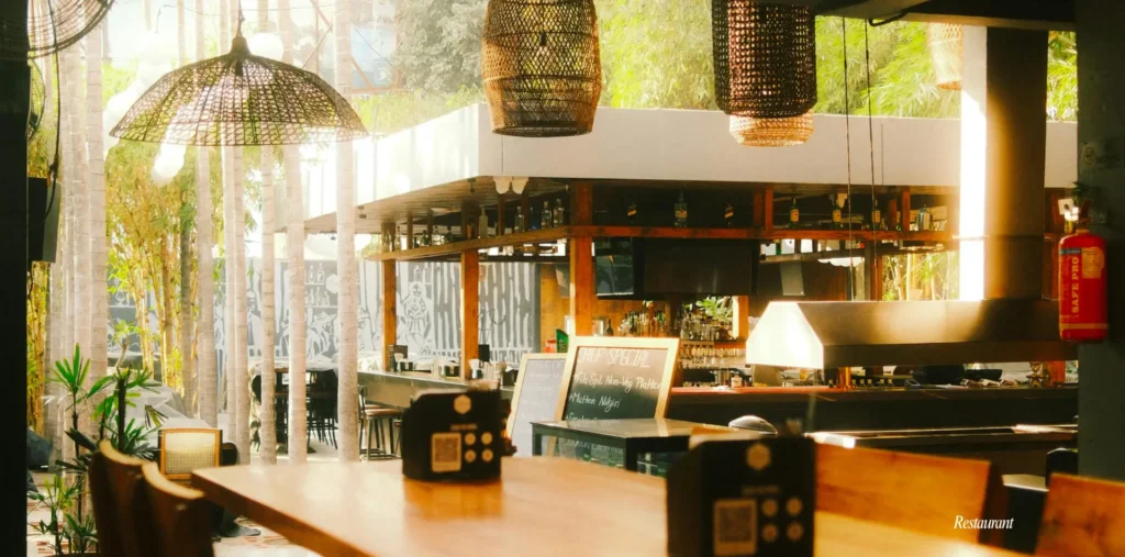 5 Fast Food Interior Design Moves That Slash Costs and Speed Up Service in Bangladesh 1 Indoor restaurant with bamboo accents and lush greenery.