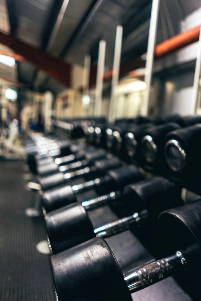 Ultimate Guide to Interior Gym Design for Professionals 2 Dumbbells and weights in gym setting.